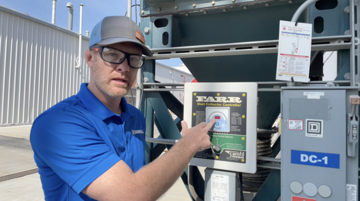 Baghouse personnel checking differential pressure in a baghouse